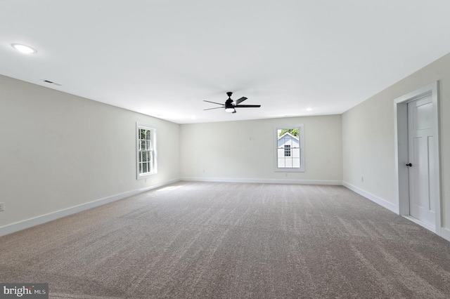 carpeted spare room featuring ceiling fan