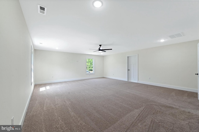 unfurnished room with ceiling fan and light colored carpet