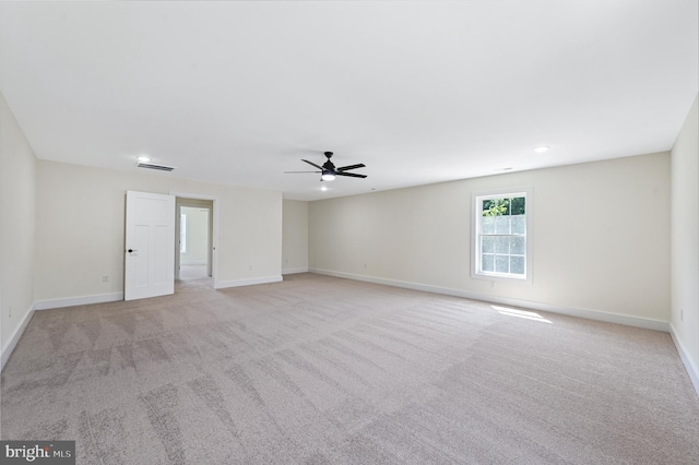 carpeted spare room with ceiling fan