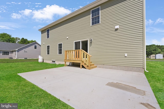 back of house with a yard and a patio