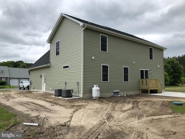 rear view of house featuring central AC unit