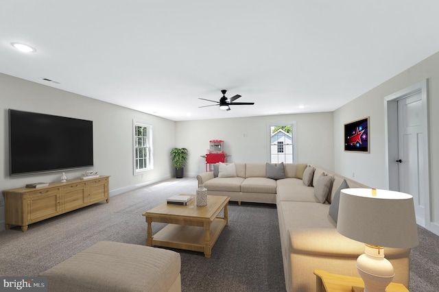 carpeted living room with ceiling fan