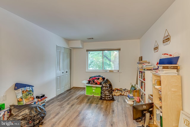 recreation room with wood-type flooring