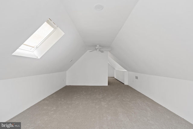 bonus room featuring carpet, ceiling fan, and lofted ceiling with skylight