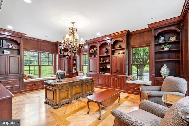 office space featuring a chandelier, ornamental molding, light parquet flooring, and a healthy amount of sunlight