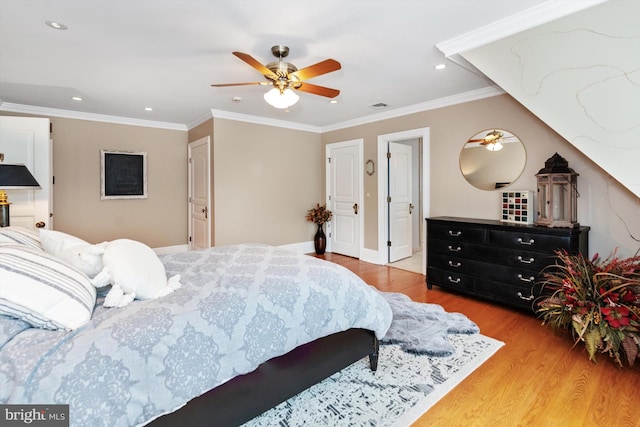 bedroom with light hardwood / wood-style floors, ceiling fan, and crown molding