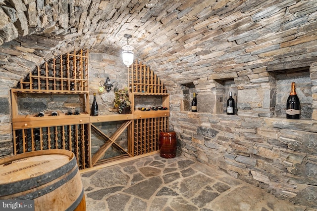 wine cellar with lofted ceiling