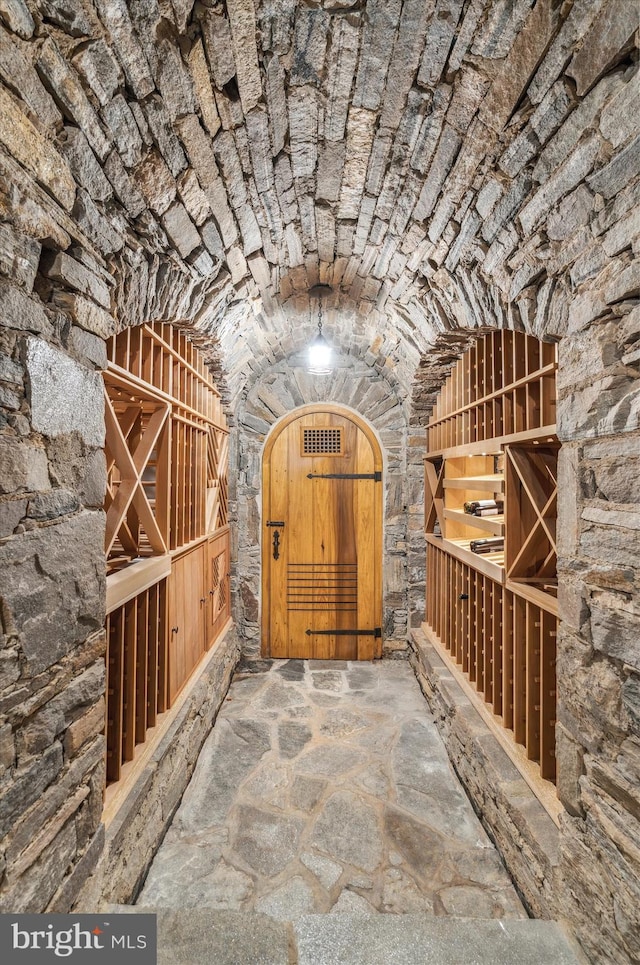 wine cellar with lofted ceiling