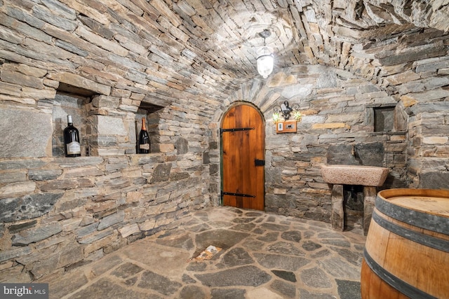 wine cellar featuring vaulted ceiling