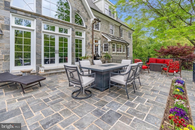 view of patio with an outdoor living space and french doors