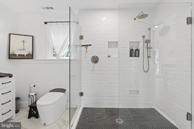 bathroom featuring vanity, toilet, and an enclosed shower