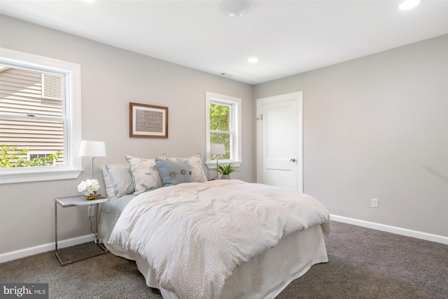 carpeted bedroom featuring multiple windows