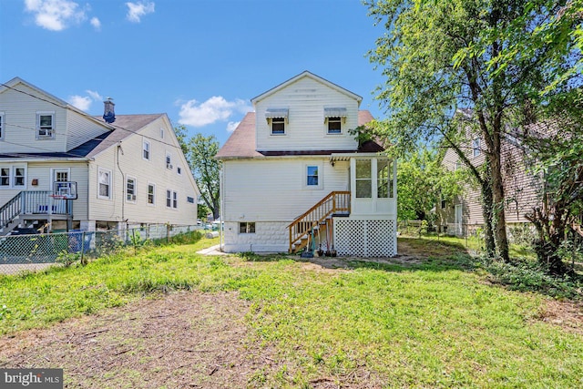 rear view of property with a lawn