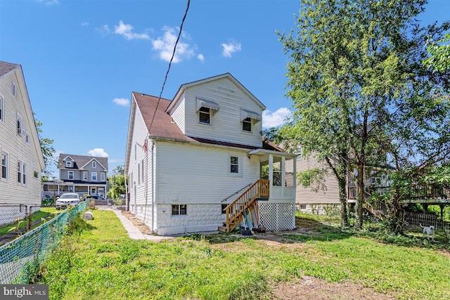 back of house with a lawn