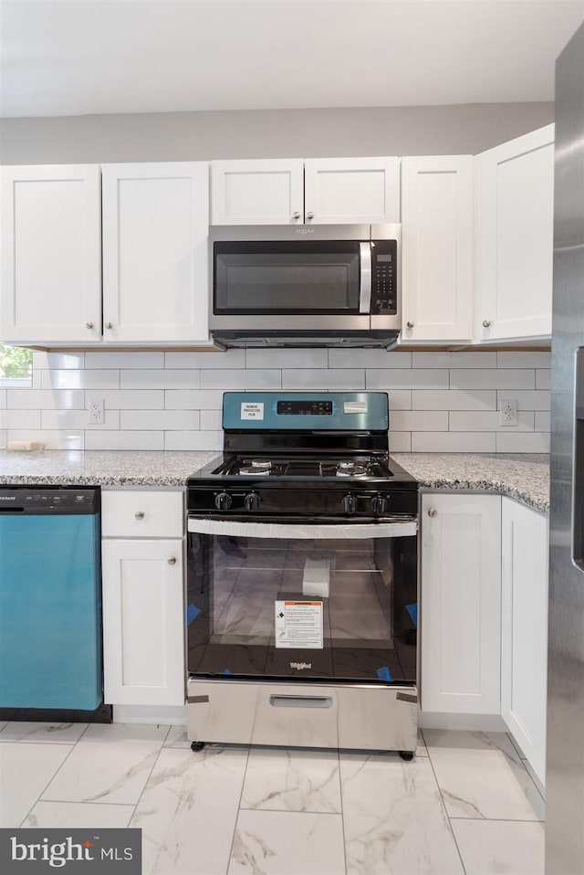 kitchen with white cabinetry and stainless steel appliances