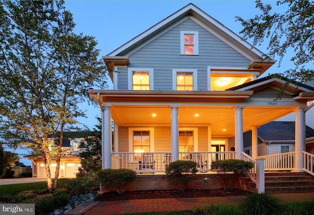 exterior space with covered porch and a garage