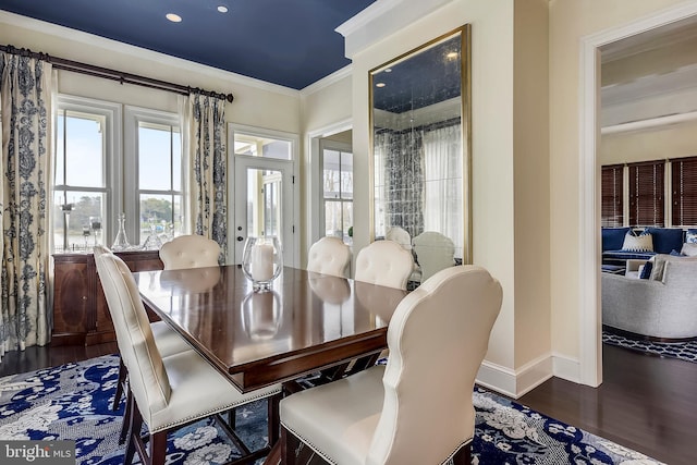 dining area with dark hardwood / wood-style flooring and ornamental molding