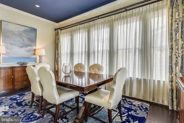 dining area featuring crown molding, a wealth of natural light, and dark wood-type flooring