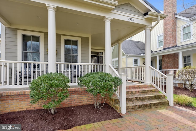 entrance to property featuring covered porch