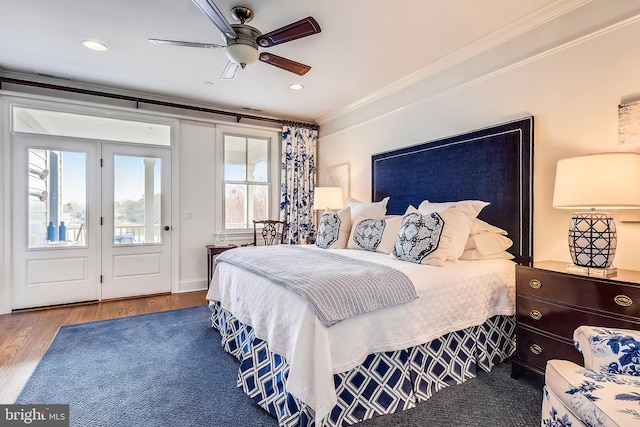 bedroom featuring crown molding, ceiling fan, and hardwood / wood-style floors