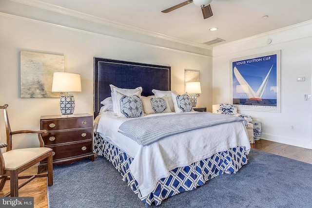 bedroom with ceiling fan, ornamental molding, and dark wood-type flooring