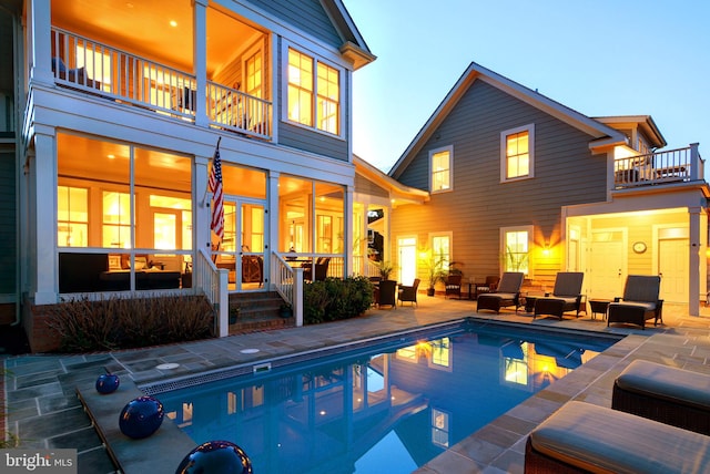 rear view of property with a patio and a balcony