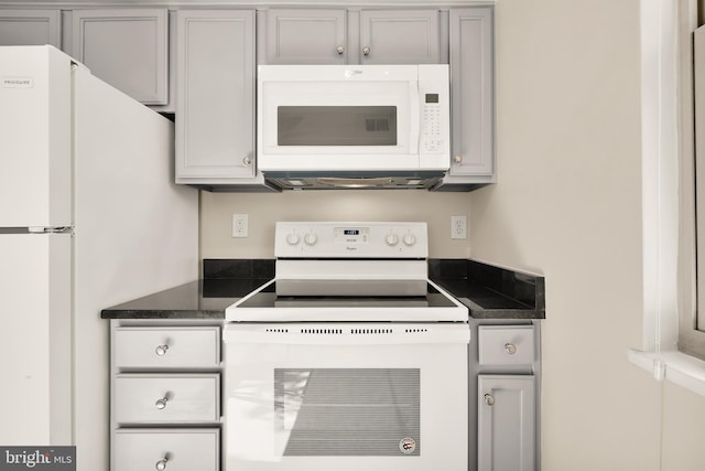 kitchen with gray cabinetry and white appliances