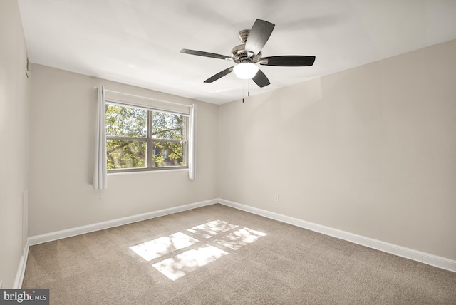 carpeted empty room with ceiling fan