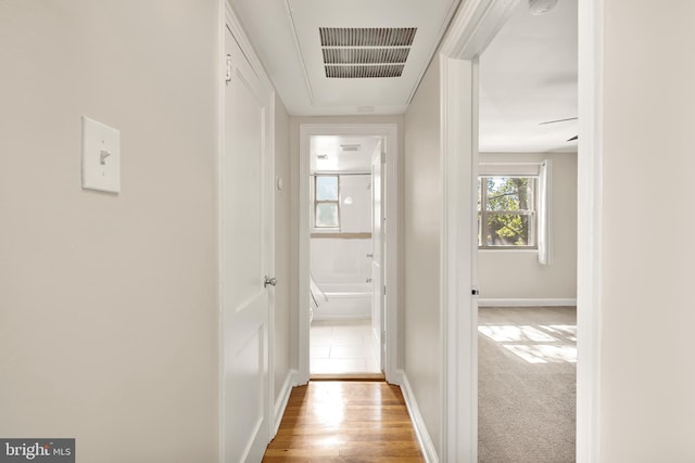 corridor with light hardwood / wood-style flooring