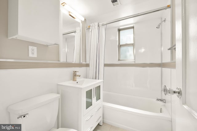 bathroom featuring tile patterned flooring, shower / tub combo with curtain, and toilet