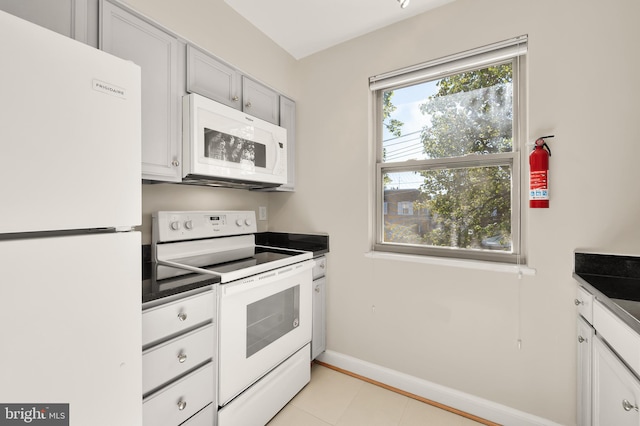 kitchen featuring white appliances and light tile patterned floors