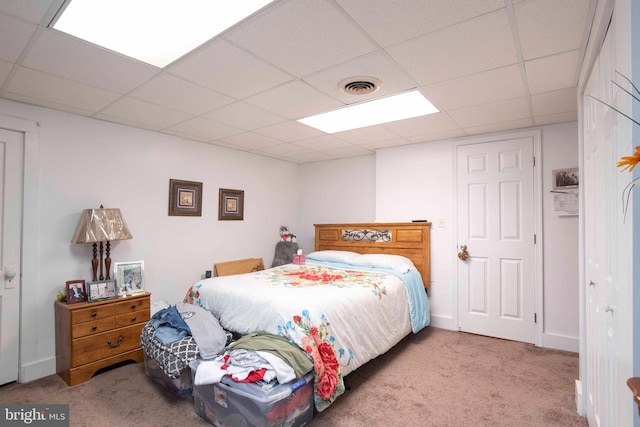 bedroom with carpet and a drop ceiling