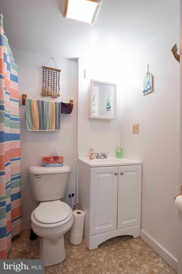 bathroom featuring tile floors, toilet, and vanity