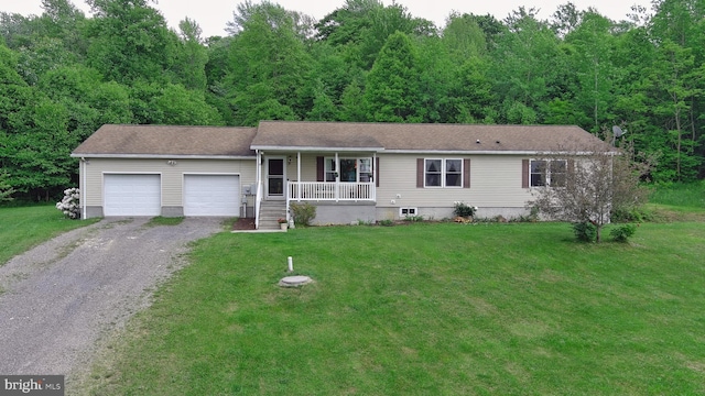 view of front of home with a garage, covered porch, and a front lawn