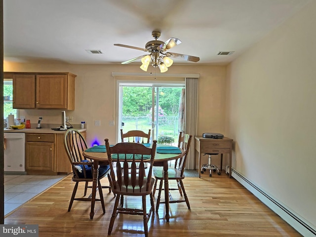 dining space featuring a baseboard radiator, light wood-type flooring, and ceiling fan