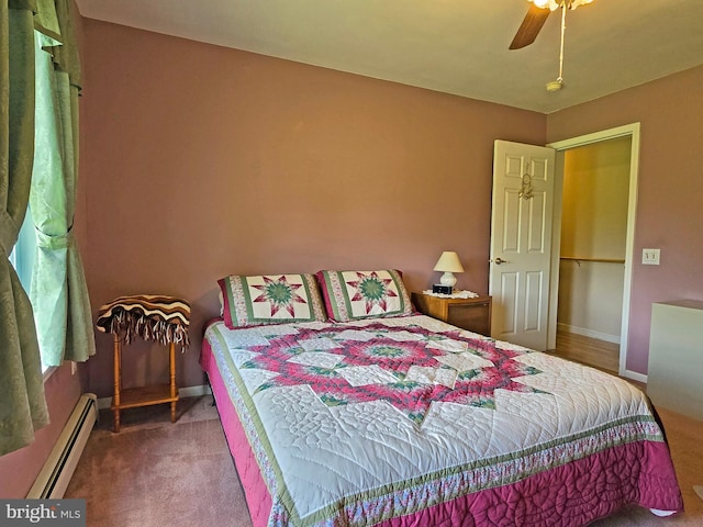 carpeted bedroom with a baseboard radiator and ceiling fan