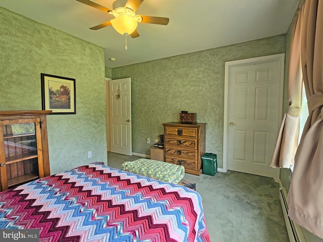 carpeted bedroom featuring ceiling fan and a baseboard heating unit