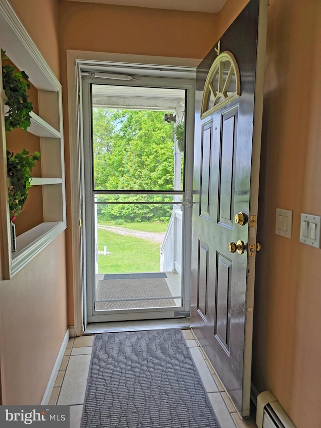 doorway to outside featuring baseboard heating and light tile patterned floors