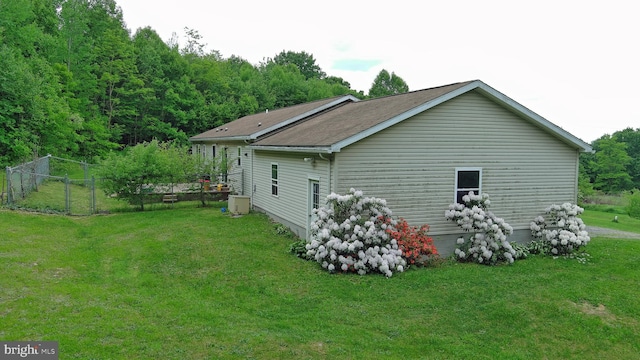 view of side of home with a yard