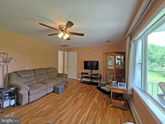 living room with hardwood / wood-style floors, ceiling fan, and a wealth of natural light