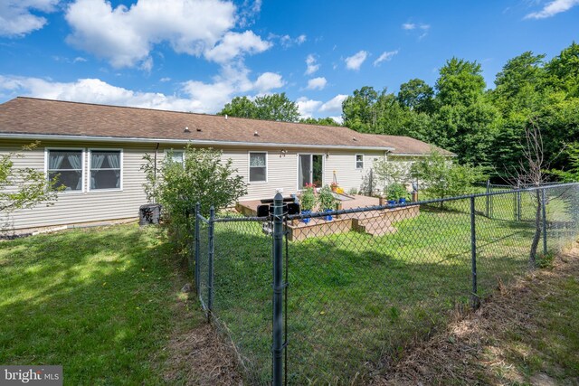 rear view of house featuring a lawn