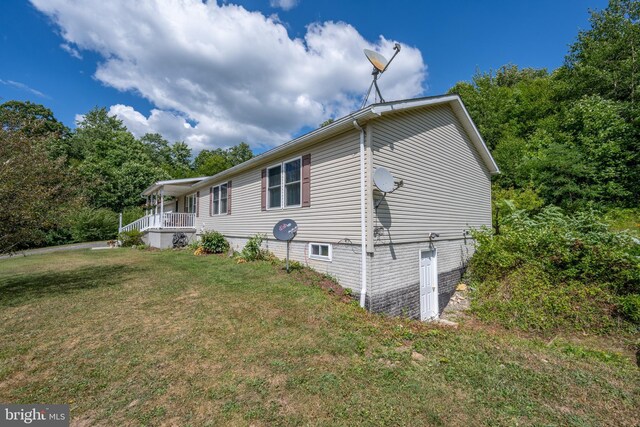 view of side of property with a lawn