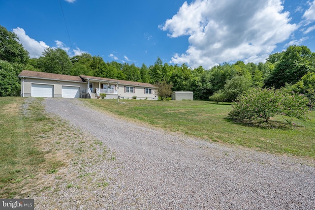 single story home featuring a garage and a front lawn