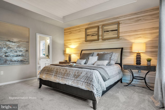 bedroom with carpet, wood ceiling, wood walls, and ensuite bathroom