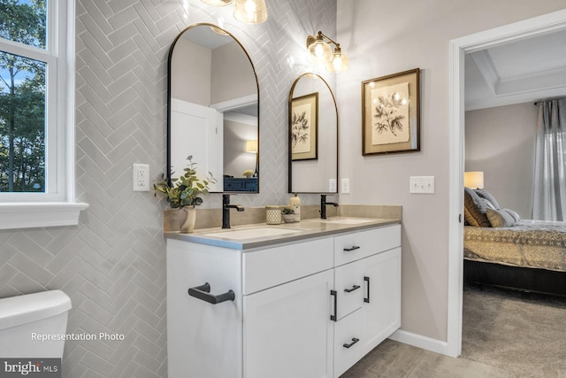 bathroom with tile walls, vanity, and toilet