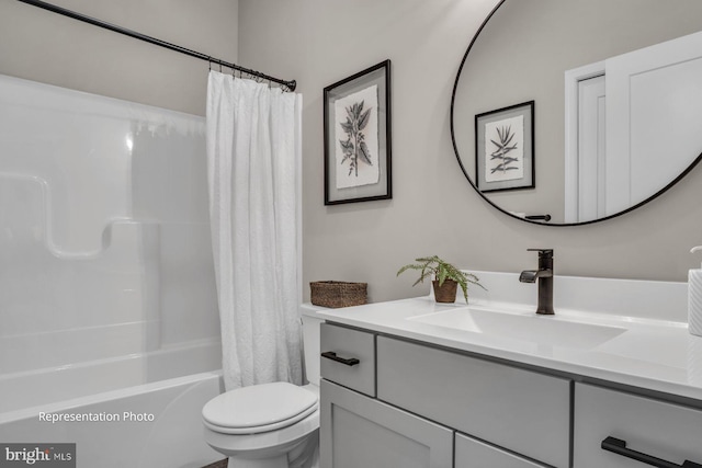 full bathroom with shower / tub combo with curtain, vanity, and toilet