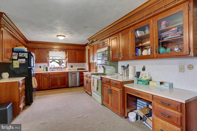 kitchen with light carpet and appliances with stainless steel finishes