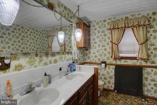 bathroom featuring vanity, a chandelier, and toilet