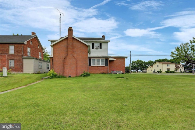 back of house with a lawn