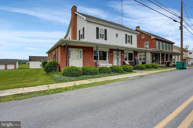 view of front of property featuring a porch and a front lawn